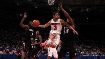 NEW YORK - MARCH 10: Peyton Siva #3 of the Louisville Cardinals looks to pass against Yancy Gates #34 of the Cincinnati Bearcats during the second round of 2010 NCAA Big East Tournament at Madison Square Garden on March 10, 2010 in New York City. (Photo by Jim McIsaac/Getty Images)