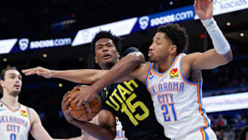 OKC Thunder guard Aaron Wiggins (21) fight for a loose ball during the second half at Paycom Center. Alonzo Adams-USA TODAY Sports