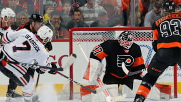 PHILADELPHIA, PA - NOVEMBER 10: Brian Elliott #37 of the Philadelphia Flyers makes a pad save on a scoring chance by Brent Seabrook #7 of the Chicago Blackhawks on November 10, 2018 at the Wells Fargo Center in Philadelphia, Pennsylvania. (Photo by Len Redkoles/NHLI via Getty Images)