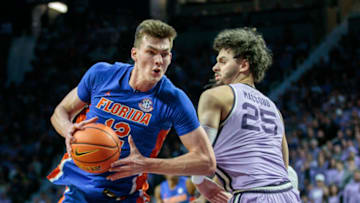 Jan 28, 2023; Manhattan, Kansas, USA; Florida Gators forward Colin Castleton (12) drives around Kansas State Wildcats forward Ismael Massoud (25) during the second half at Bramlage Coliseum. Mandatory Credit: William Purnell-USA TODAY Sports