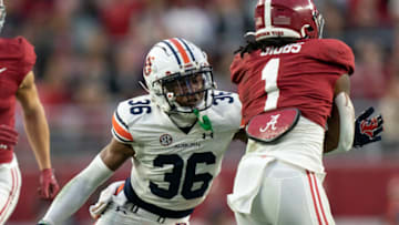 Auburn footballNov 26, 2022; Tuscaloosa, Alabama, USA; Auburn Tigers cornerback Jaylin Simpson (36) grabs Alabama Crimson Tide running back Jahmyr Gibbs (1) during the first half at Bryant-Denny Stadium. Mandatory Credit: Marvin Gentry-USA TODAY Sports
