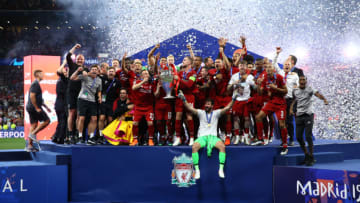 Liverpool players celebrate with the trophy on the stage during the UEFA Champions League Final Tottenham Hotspur Fc v Liverpool Fc awards ceremony at the Wanda Metropolitano Stadium in Madrid, Spain on June 1, 2019 (Photo by Matteo Ciambelli/NurPhoto via Getty Images)