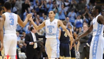 Feb 14, 2016; Chapel Hill, NC, USA; North Carolina Tar Heels guard Marcus Paige (5) and forward Kennedy Meeks (3) and forward Theo Pinson (1) celebrate during the second half in game against the Pittsburgh Panthers at Dean E. Smith Center. The Tar Heels won 85-64. Mandatory Credit: Evan Pike-USA TODAY Sports