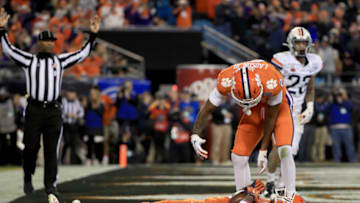 CHARLOTTE, NORTH CAROLINA - DECEMBER 07: Tee Higgins #5 celebrates after scoring a touchdown with teammate Frank Ladson Jr. #2 of the Clemson Tigers against the Virginia Cavaliers during the ACC Football Championship game at Bank of America Stadium on December 07, 2019 in Charlotte, North Carolina. (Photo by Streeter Lecka/Getty Images)