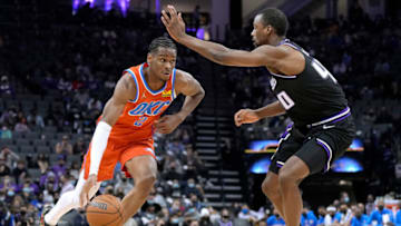 Shai Gilgeous-Alexander #2 of the Oklahoma City Thunder drives to the basket on Harrison Barnes #40 of the Sacramento Kings during the fourth quarter at Golden 1 Center on December 28, 2021 in Sacramento, California. NOTE TO USER: User expressly acknowledges and agrees that, by downloading and or using this photograph, User is consenting to the terms and conditions of the Getty Images License Agreement. (Photo by Thearon W. Henderson/Getty Images)