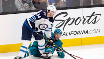 Mar 28, 2023; San Jose, California, USA; Winnipeg Jets defenseman Dylan Samberg (54) and San Jose Sharks center Tomas Hertl (48) battle for the puck during the third period at SAP Center at San Jose. Mandatory Credit: D. Ross Cameron-USA TODAY Sports