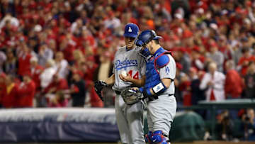 Oct 13, 2016; Washington, DC, USA; Los Angeles Dodgers starting pitcher Rich Hill (44) talks with catcher Yasmani Grandal (right) during the second inning against the Washington Nationals during game five of the 2016 NLDS playoff baseball game at Nationals Park. Mandatory Credit: Geoff Burke-USA TODAY Sports