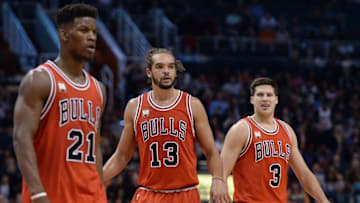 Nov 18, 2015; Phoenix, AZ, USA; Chicago Bulls center Joakim Noah (13) reacts on the court in-between teammates guard Jimmy Butler (21) and forward Doug McDermott (3) at Talking Stick Resort Arena. The Bulls won 103-97. Mandatory Credit: Jennifer Stewart-USA TODAY Sports