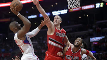 December 12, 2016; Los Angeles, CA, USA; Los Angeles Clippers guard Chris Paul (3) shoots against the defense of Portland Trail Blazers center Mason Plumlee (24) and guard Evan Turner (1) during the second half at Staples Center. Mandatory Credit: Gary A. Vasquez-USA TODAY Sports