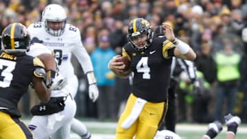 IOWA CITY, IOWA- NOVEMBER 10: Quarterback Nate Stanley #4 of the Iowa Hawkeyes is tripped up on a keeper during the first half by defensive end Earnest Brown #98 of the Northwestern Wildcats on November 10, 2018 at Kinnick Stadium, in Iowa City, Iowa. (Photo by Matthew Holst/Getty Images)