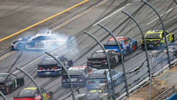 TALLADEGA, ALABAMA - JUNE 22: Aric Almirola, driver of the #10 Smithfield Ford, is involved in an on-track incident as Ryan Blaney, driver of the #12 Menards/Sylvania Ford, races to the finish line ahead of Ricky Stenhouse Jr., driver of the #47 NOS Energy Drink Chevrolet, during the NASCAR Cup Series GEICO 500 at Talladega Superspeedway on June 22, 2020 in Talladega, Alabama. (Photo by Brian Lawdermilk/Getty Images)