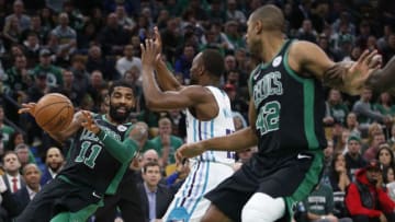 BOSTON - DECEMBER 23: Celics Kyrie Irving looks to pass against Hornets Kemba Walker as Celtics Al Horfod runs in during the first quarter of play at TD Garden in Boston on Dec. 23, 2018. (Photo by Jessica Rinaldi/The Boston Globe via Getty Images)