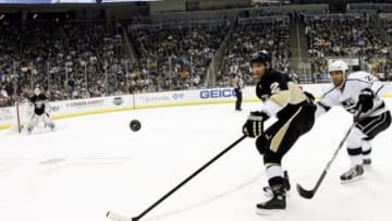Mar 27, 2014; Pittsburgh, PA, USA; Pittsburgh Penguins defenseman Matt Niskanen (2) and Los Angeles Kings defenseman Matt Greene (right) chase the puck during the first period at the CONSOL Energy Center. The Kings won 3-2. Mandatory Credit: Charles LeClaire-USA TODAY Sports