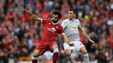 LIVERPOOL, ENGLAND - OCTOBER 14: Mohamed Salah of Liverpool and Matteo Darmian of Manchester United battle for possession during the Premier League match between Liverpool and Manchester United at Anfield on October 14, 2017 in Liverpool, England. (Photo by Shaun Botterill/Getty Images)