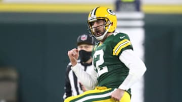 Jan 16, 2021; Green Bay, Wisconsin, USA; Green Bay Packers quarterback Aaron Rodgers (12) celebrates after a touchdown pass to wide receiver Allen Lazard (13) during the second half of a NFC Divisional Round playoff game against the Los Angeles Rams at Lambeau Field. Mandatory Credit: Mark J. Rebilas-USA TODAY Sports