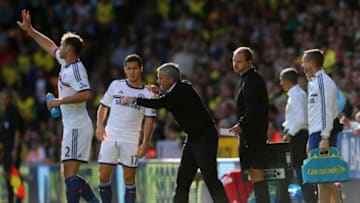 NORWICH, ENGLAND - OCTOBER 06: Manager Jose Mourinho of Chelsea speaks to Eden Hazard of Chelsea during the Barclays Premier League match between Norwich City and Chelsea at Carrow Road on October 6, 2013 in Norwich, England. (Photo by Julian Finney/Getty Images)