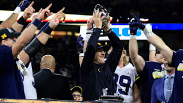 INDIANAPOLIS, INDIANA - DECEMBER 04: Head coach Jim Harbaugh of the Michigan Wolverines celebrates winning Big Ten Football Championship over the Iowa Hawkeyes at Lucas Oil Stadium on December 04, 2021 in Indianapolis, Indiana. (Photo by Justin Casterline/Getty Images)
