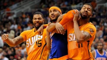 Mar 28, 2014; Phoenix, AZ, USA; New York Knicks forward Carmelo Anthony (7) and Phoenix Suns forward Marcus Morris (15) and forward Markieff Morris (11) battle for positioning during the second quarter at US Airways Center. The Suns won 112-88. Mandatory Credit: Casey Sapio-USA TODAY Sports