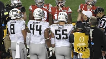 Jan 12, 2015; Arlington, TX, USA; Team members meet for the coin toss prior to the game between the Ohio State Buckeyes and the Oregon Ducks in the 2015 CFP National Championship at AT&T Stadium. Mandatory Credit: Jerome Miron-USA TODAY Sports