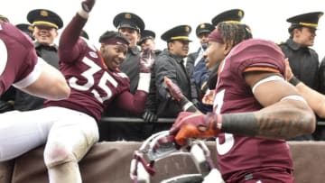 BLACKSBURG, VA - DECEMBER 1: Defensive lineman Zion Debose #35 and running back Deshawn McClease #33 of the Virginia Tech Hokies celebrate with the Corps of Cadets following the victory against the Marshall Thundering Herd at Lane Stadium on December 1, 2018 in Blacksburg, Virginia. (Photo by Michael Shroyer/Getty Images)