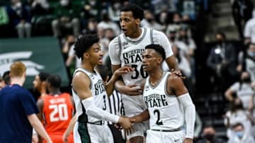 Michigan State's Jaden Akins, left, and Marcus Bingham Jr., center, celebrate with Tyson Walker after Walker scored against Illinois during the second half Saturday, Feb. 19, 2022, at the Breslin Center in East Lansing.Syndication Lansing State Journal