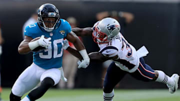 JACKSONVILLE, FL - SEPTEMBER 16: Corey Grant #30 of the Jacksonville Jaguars runshes past Jonathan Jones #31 of the New England Patriots during the game at TIAA Bank Field on September 16, 2018 in Jacksonville, Florida. (Photo by Sam Greenwood/Getty Images)