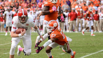 October 15, 2016: Clemson defensive back Van Smith (23) dives to tackle NC States Ryan Finley (15) during 2nd half action between the Clemson Tigers and the NC State Wolfpack at Memorial Stadium in Clemson, SC. (photo by Doug Buffington/Icon Sportswire via Getty Images).