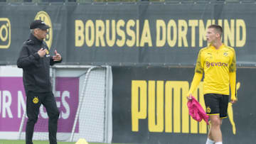 DORTMUND, GERMANY - AUGUST 18: Head coach Lucien Favre of Borussia Dortmund speaks with Tobias Raschl of Borussia Dortmund during the Borussia Dortmund Training Session on August 18, 2019 in Dortmund, Germany. (Photo by TF-Images/Getty Images)