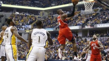 Apr 28, 2014; Indianapolis, IN, USA; Atlanta Hawks forward Paul Millsap (4) lays the ball in against Indiana Pacers guard Lance Stephenson (1) in game five of the first round of the 2014 NBA Playoffs at Bankers Life Fieldhouse. Mandatory Credit: Brian Spurlock-USA TODAY Sports