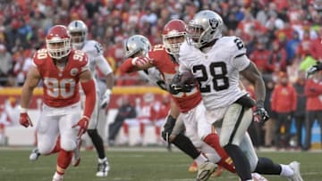 Jan 3, 2016; Kansas City, MO, USA; Oakland Raiders running back Latavius Murray (28) runs the ball as Kansas City Chiefs inside linebacker Josh Mauga (90) defends during the first half at Arrowhead Stadium. Mandatory Credit: Denny Medley-USA TODAY Sports
