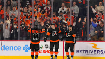Dec 18, 2021; Philadelphia, Pennsylvania, USA; Philadelphia Flyers defenseman Travis Sanheim (6) celebrates with center Scott Laughton (21) and right wing Travis Konecny (11) after scoring the game winning goal against the Ottawa Senators in overtime at the Wells Fargo Center. Mandatory Credit: Mitchell Leff-USA TODAY Sports