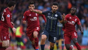 Manchester City's Argentinian striker Sergio Aguero (2R) vies with Liverpool's Scottish defender Andrew Robertson (L), Liverpool's Brazilian midfielder Roberto Firmino (2L) and Liverpool's Guinean midfielder Naby Keita during the English Premier League football match between Liverpool and Manchester City at Anfield in Liverpool, north west England on October 7, 2018. (Photo by Paul ELLIS / AFP) / RESTRICTED TO EDITORIAL USE. No use with unauthorized audio, video, data, fixture lists, club/league logos or 'live' services. Online in-match use limited to 120 images. An additional 40 images may be used in extra time. No video emulation. Social media in-match use limited to 120 images. An additional 40 images may be used in extra time. No use in betting publications, games or single club/league/player publications. / (Photo credit should read PAUL ELLIS/AFP/Getty Images)