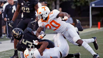 NASHVILLE, TN - NOVEMBER 24: Bryce Thompson #20 of the Tennessee Volunteers hits Ke'Shawn Vaughn #5 of the Vanderbilt Commodores in the helmet during the first half at Vanderbilt Stadium on November 24, 2018 in Nashville, Tennessee. (Photo by Frederick Breedon/Getty Images)