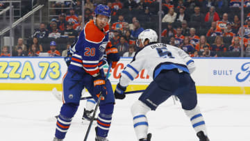 Sep 24, 2023; Edmonton, Alberta, CAN; Edmonton Oilers forward Brandon Sutter (20) and Winnipeg Jets defensemen Brenden Dillon (5) battle for position during the first period at Rogers Place. Mandatory Credit: Perry Nelson-USA TODAY Sports