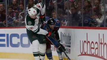DENVER, CO - OCTOBER 04: Eric Fehr #21 of the Minnesota Wild fights for the puck on the boards with Tyson Barrie #4 of the Colorado Avalanche at the Pepsi Center on October 4, 2018 in Denver, Colorado. (Photo by Matthew Stockman/Getty Images)