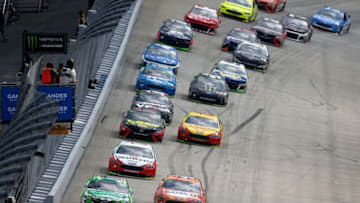 DOVER, DE - OCTOBER 07: Kyle Busch, driver of the #18 Interstate Batteries Toyota, and Kevin Harvick, driver of the #4 Busch Outdoors Ford, lead the field during the Monster Energy NASCAR Cup Series Gander Outdoors 400 at Dover International Speedway on October 7, 2018 in Dover, Delaware. (Photo by Jonathan Ferrey/Getty Images)