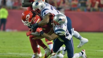 Sep 29, 2014; Kansas City, MO, USA; Kansas City Chiefs running back Jamaal Charles (25) is tackled by New England Patriots tackle Sebastian Vollmer (76) during the first half at Arrowhead Stadium. Mandatory Credit: Denny Medley-USA TODAY Sports