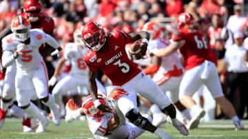 LOUISVILLE, KENTUCKY - OCTOBER 19: Micale Cunningham #6 of the Louisville Cardinals runs with the ball while sacked by Isaiah Simmons #11 of the Clemson Tigers at Cardinal Stadium on October 19, 2019 in Louisville, Kentucky. (Photo by Andy Lyons/Getty Images)