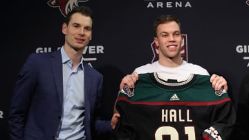 PHOENIX, ARIZONA - DECEMBER 18: (L-R) General manager John Chayka and Taylor Hall of the Arizona Coyotes pose together during a introductory press conference at Gila River Arena on December 18, 2019 in Glendale, Arizona. (Photo by Christian Petersen/Getty Images)