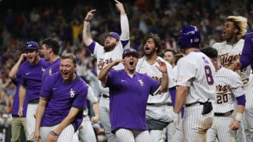 HOUSTON, TEXAS - MARCH 04: The LSU Tigers bench players celebrate a walk-off home run by Jordan Thompson #13 in the eleventh inning to defeat the Oklahoma Sooners during the Shriners Children's College Classic at Minute Maid Park on March 04, 2022 in Houston, Texas. (Photo by Bob Levey/Getty Images)