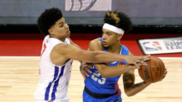 Killian Hayes #7 of the Pistons tries to steal the ball from Tre Mann #23 of the OKC Thunder. (Photo by Ethan Miller/Getty Images)