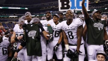 Dec 5, 2015; Indianapolis, IN, USA; Michigan State players celebrate after defeating the Iowa Hawkeyes during in the Big Ten Conference football championship game at Lucas Oil Stadium. Mandatory Credit: Brian Spurlock-USA TODAY Sports