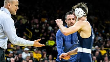 Penn State head coach Cael Sanderson, left, high-fives wrestler Drew Hildebrandt after his major decision win at 125 pounds during a NCAA Big Ten Conference wrestling dual against Iowa, Friday, Jan. 28, 2022, at Carver-Hawkeye Arena in Iowa City, Iowa.220127 Penn St Iowa Wr 033 Jpg