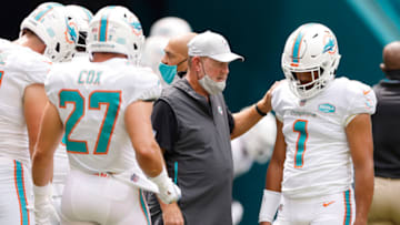 MIAMI GARDENS, FLORIDA - OCTOBER 04: Offensive coordinator Chan Gailey of the Miami Dolphins talks with Tua Tagovailoa #1 prior to the game against the Seattle Seahawks at Hard Rock Stadium on October 04, 2020 in Miami Gardens, Florida. (Photo by Michael Reaves/Getty Images)