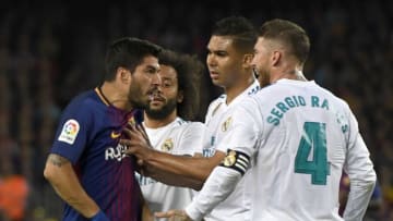 BARCELONA, SPAIN - MAY 06: Luis Suarez of Barcelona clashes with Sergio Ramos and Casemiro of Real Madrid during the La Liga match between Barcelona and Real Madrid at Camp Nou on May 6, 2018 in Barcelona, Spain. (Photo by Alex Caparros/Getty Images)