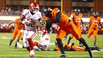 Nov 28, 2015; Stillwater, OK, USA; Oklahoma Sooners running back Samaje Perine (left) runs into the end zone for a touchdown against the Oklahoma State Cowboys in the second quarter at Boone Pickens Stadium. Mandatory Credit: Mark J. Rebilas-USA TODAY Sports
