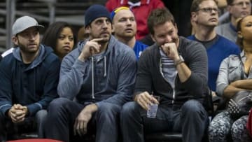 Jan 7, 2014; Milwaukee, WI, USA; Green Bay Packers quarterback Aaron Rodgers looks from the court at the game between the Golden State Warriors and the Milwaukee Bucks at BMO Harris Bradley Center. Mandatory Credit: Jeff Hanisch-USA TODAY Sports