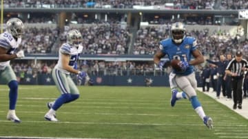 Jan 4, 2015; Arlington, TX, USA; Detroit Lions running back Reggie Bush (21) scores on a touchdown run past Dallas Cowboys outside linebacker Anthony Hitchens (59) and Sterling Moore (26) during the first quarter in the NFC Wild Card Playoff Game at AT&T Stadium. Mandatory Credit: Tim Heitman-USA TODAY Sports
