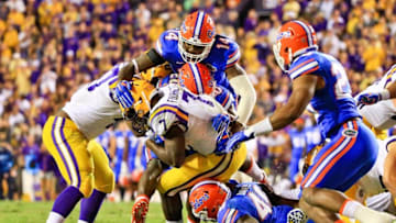 Oct 17, 2015; Baton Rouge, LA, USA; Florida Gators defensive lineman Alex McCalister (14) and defensive back Marcus Maye (20) and linebacker Jarrad Davis (40) combine to tackle LSU Tigers running back Leonard Fournette (7) during the second half of a game at Tiger Stadium. LSU defeated Florida 35-28. Mandatory Credit: Derick E. Hingle-USA TODAY Sports