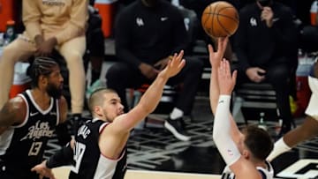 May 22, 2021; Los Angeles, California, USA; Dallas Mavericks guard Luka Doncic (77) shoots over LA Clippers center Ivica Zubac (40) during the third quarter of game one in the first round of the 2021 NBA Playoffs at Staples Center. Mandatory Credit: Robert Hanashiro-USA TODAY Sports
